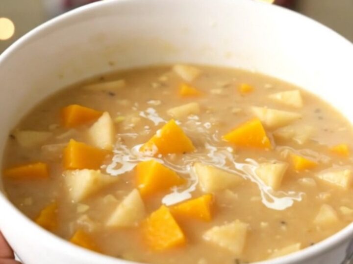 A bowl of creamy butternut squash and apple chowder with a smooth, orange texture.