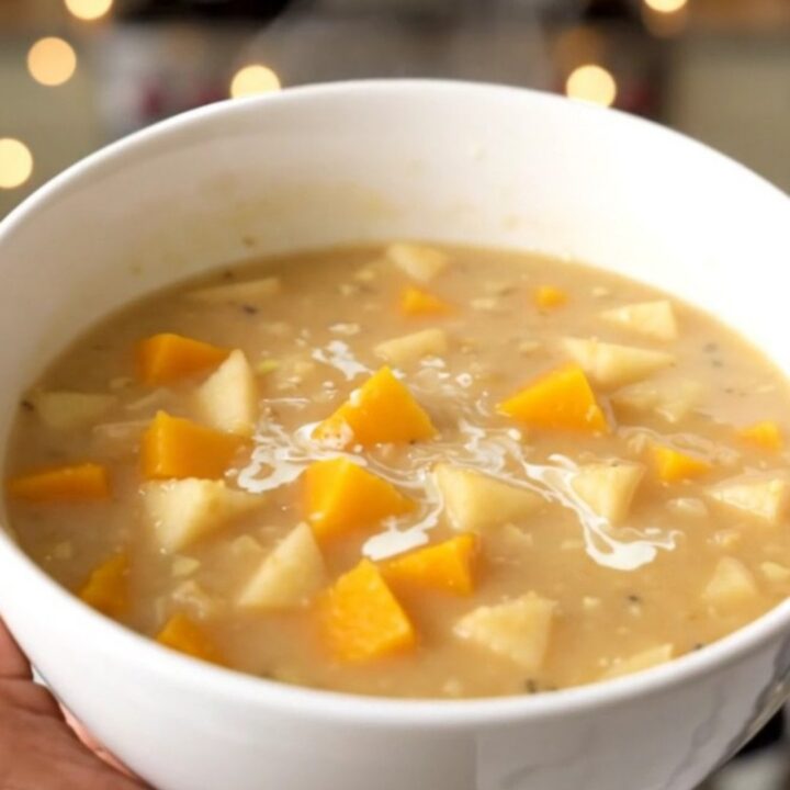 A bowl of creamy butternut squash and apple chowder with a smooth, orange texture.