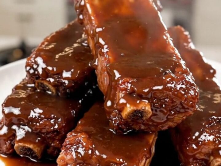 A plate of tender, slow-cooked chipotle honey country-style ribs with a glossy glaze.