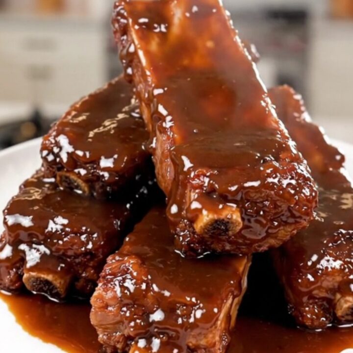A plate of tender, slow-cooked chipotle honey country-style ribs with a glossy glaze.