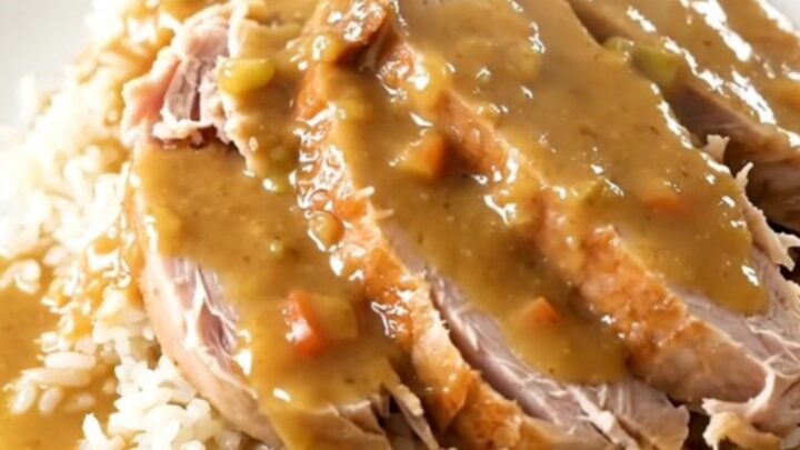 A close-up shot of creamy ranch turkey tenderloin served over white rice with tender carrots.