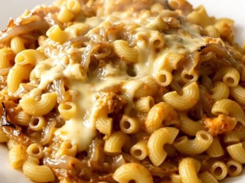 A top-down view of the creamy French onion macaroni and cheese in a slow cooker.