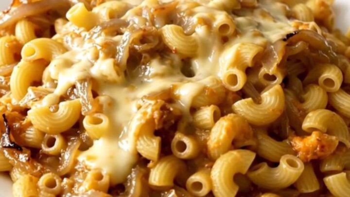 A top-down view of the creamy French onion macaroni and cheese in a slow cooker.