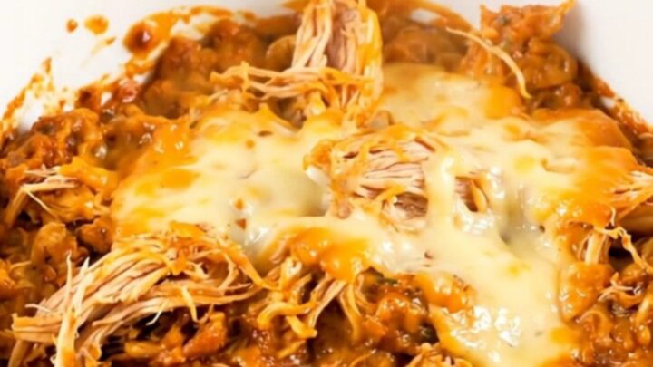 A top-down view of chicken and sweet potatoes in a slow cooker with a creamy sauce.