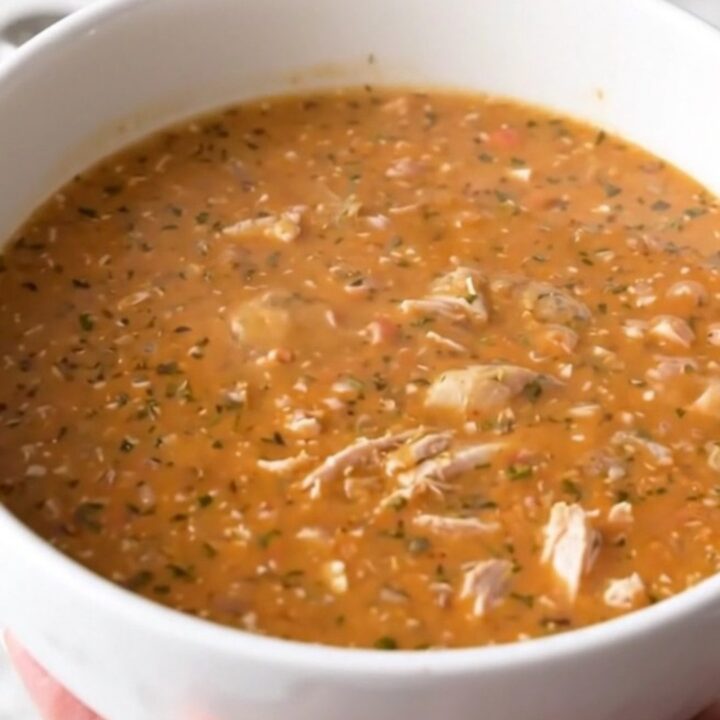A steaming bowl of creamy buffalo turkey chowder with chunks of tender potatoes and ground turkey.