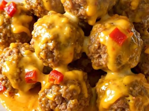 A slow cooker filled with beef meatballs covered in a rich, creamy chipotle cheddar sauce.
