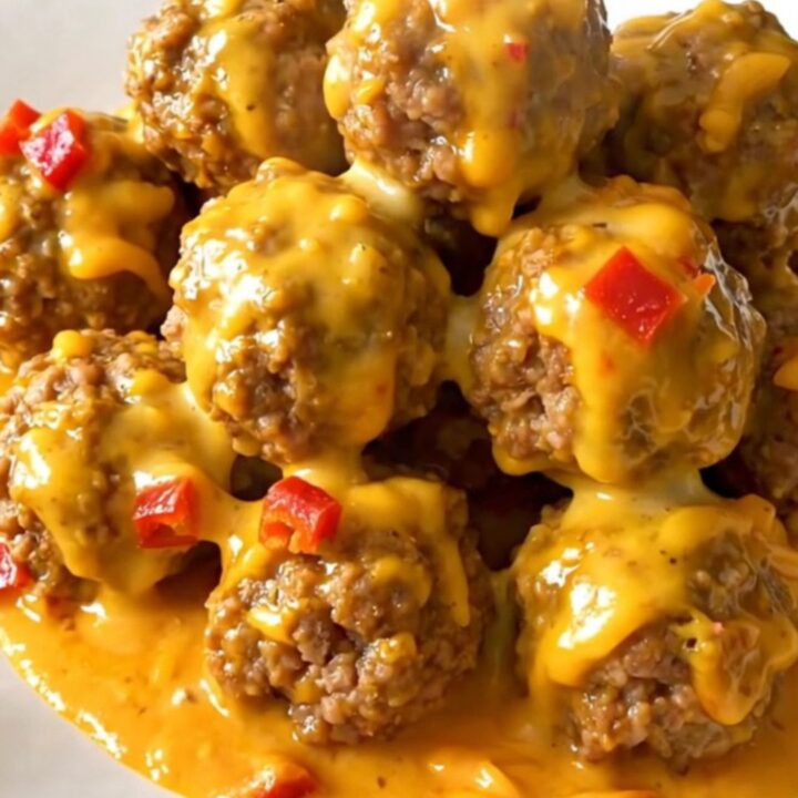 A slow cooker filled with beef meatballs covered in a rich, creamy chipotle cheddar sauce.