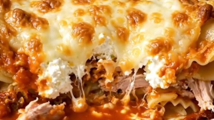 A steaming, glossy ground turkey lasagna casserole served on a white plate.