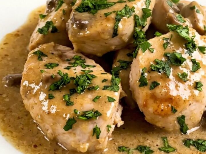 A top-down view of a slow cooker filled with creamy mushroom chicken before cooking.