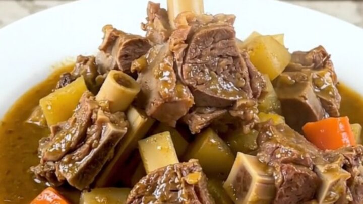 A close-up of a steaming bowl of lamb navarin with tender chunks of meat and perfectly cooked root vegetables.