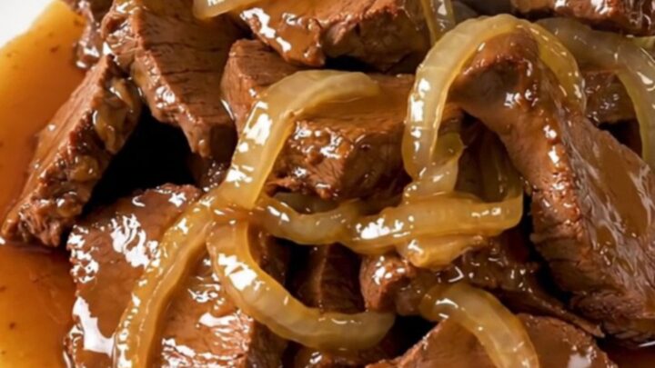 Slow-cooked veal tendrons with caramelized onions in a rich honey soy sauce on a white plate.