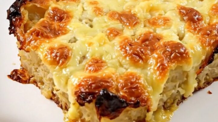 A warm, golden-brown slow cooker red kuri squash and Comté gratin in a white bowl.