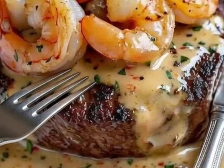 A beautifully seared filet mignon topped with large, succulent shrimp and drizzled with a rich herb butter sauce.