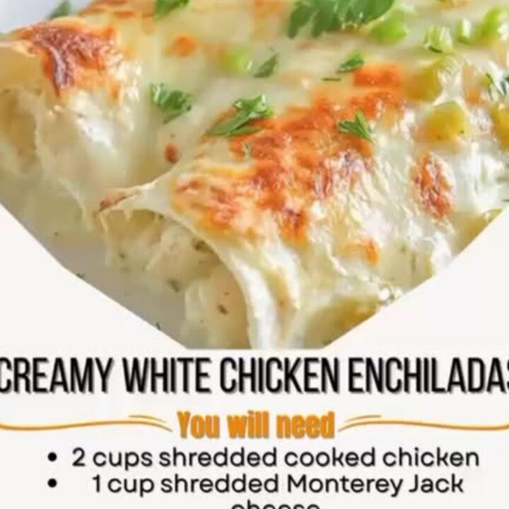 Close-up of a spatula lifting a creamy white chicken enchilada with a long, gooey cheese pull and sauce.