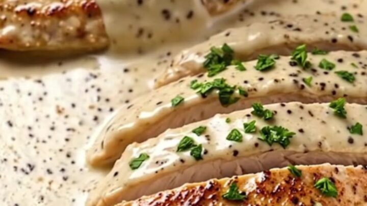 Creamy garlic butter chicken breast served in a skillet with a rich, velvety sauce and fresh parsley garnish.