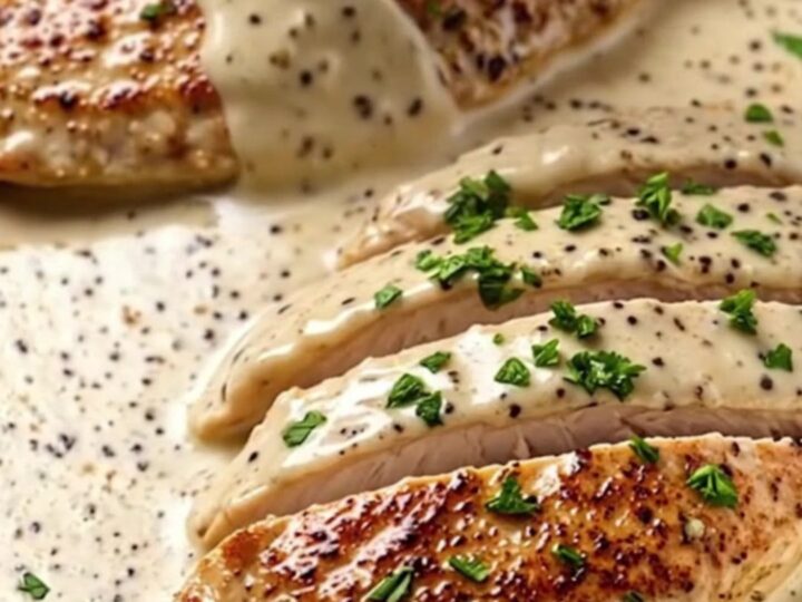 Creamy garlic butter chicken breast served in a skillet with a rich, velvety sauce and fresh parsley garnish.