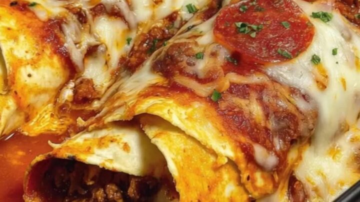 A close-up of a spatula lifting a pizza enchilada with a long, satisfying stretch of melted mozzarella cheese.