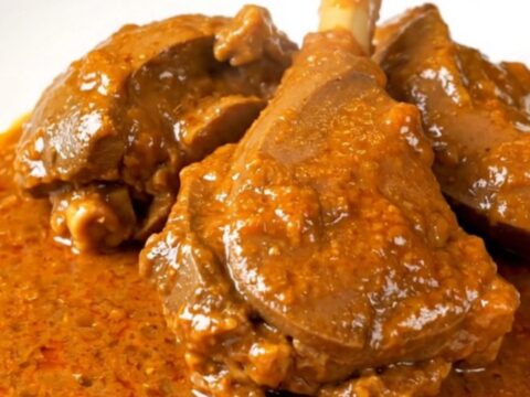 A bowl of slow-cooked veal in a rich, creamy paprika sauce served on a white plate.