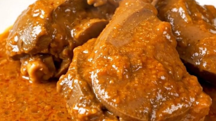 A bowl of slow-cooked veal in a rich, creamy paprika sauce served on a white plate.