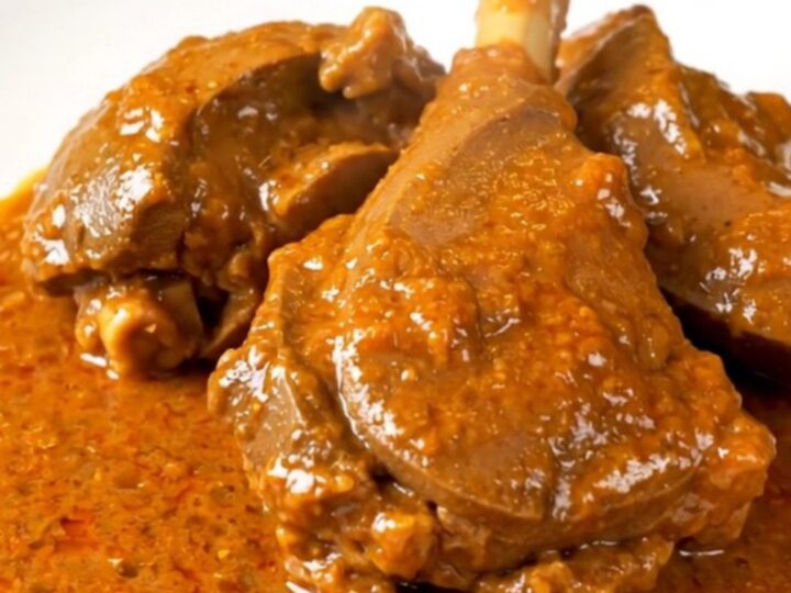 A bowl of slow-cooked veal in a rich, creamy paprika sauce served on a white plate.
