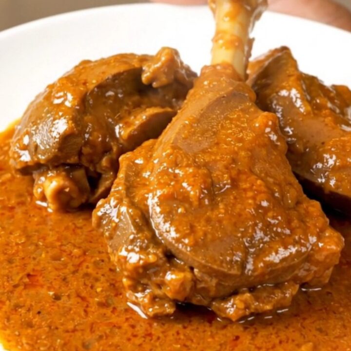 A bowl of slow-cooked veal in a rich, creamy paprika sauce served on a white plate.
