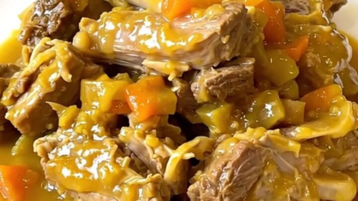 A top-down view of a slow cooker filled with raw turkey, potatoes, zucchini, and spices.