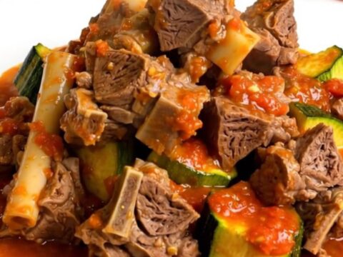 Slow cooker lamb stew with zucchini and tomatoes served in a bowl.