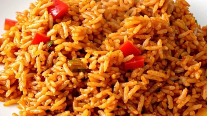 Slow cooker filled with white rice, colorful bell peppers, sliced onions, and tomato coulis.