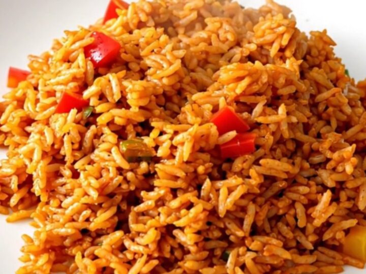 Slow cooker filled with white rice, colorful bell peppers, sliced onions, and tomato coulis.