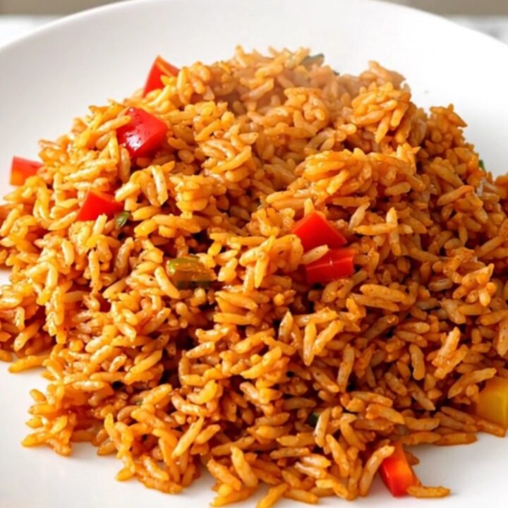 Slow cooker filled with white rice, colorful bell peppers, sliced onions, and tomato coulis.
