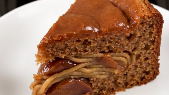A warm, moist slice of chestnut cake on a white plate, showing a dense, rich texture.