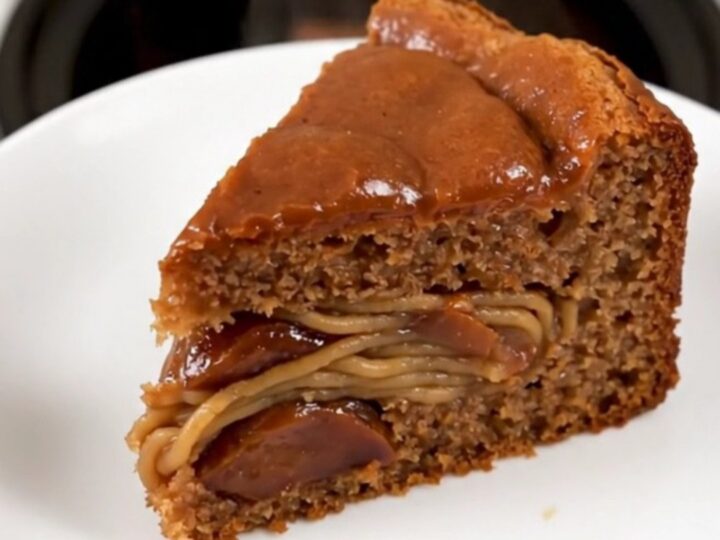 A warm, moist slice of chestnut cake on a white plate, showing a dense, rich texture.