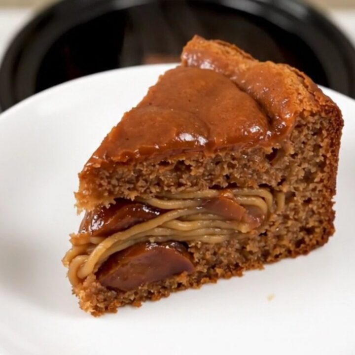 A warm, moist slice of chestnut cake on a white plate, showing a dense, rich texture.