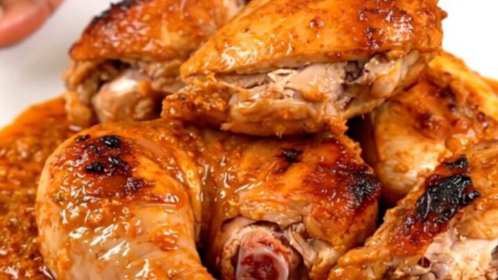A close-up of tender, spiced tandoori chicken legs served on a white plate.