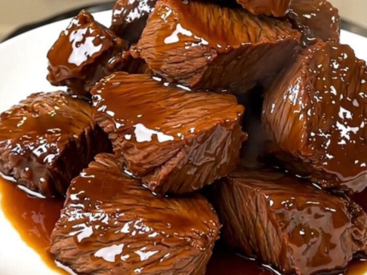 A close-up of tender, glazed beef chuck chunks in a dark, glossy balsamic sauce.