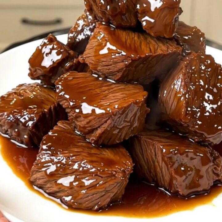 A close-up of tender, glazed beef chuck chunks in a dark, glossy balsamic sauce.