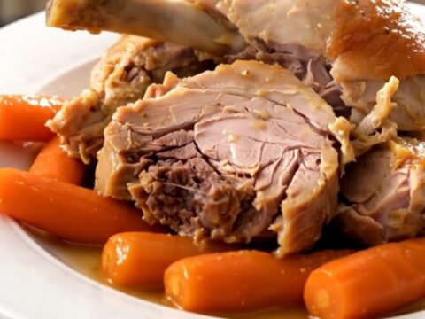 Two tender turkey drumsticks braised with carrots and onions in a white wine sauce.
