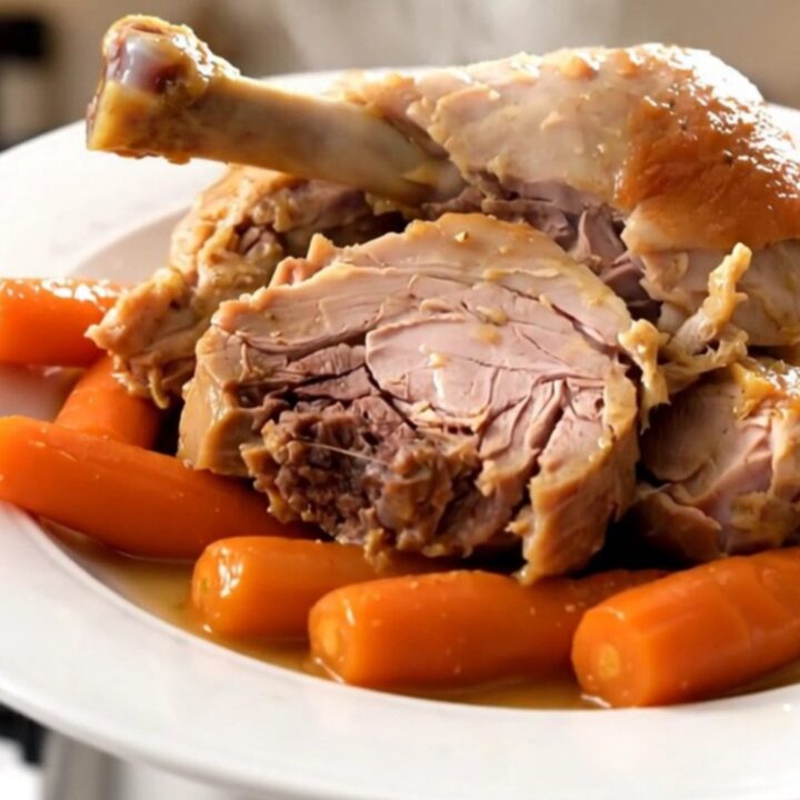 Two tender turkey drumsticks braised with carrots and onions in a white wine sauce.