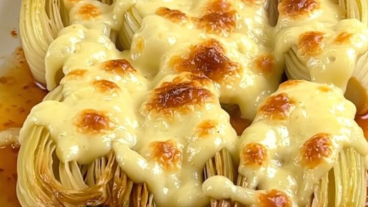 Braised endives coated in a glossy, melted Comté cheese sauce in a slow cooker.