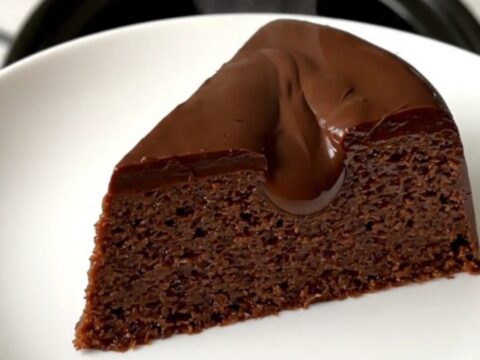 A glossy, steaming slice of chocolate chestnut fondant served on a clean white plate.