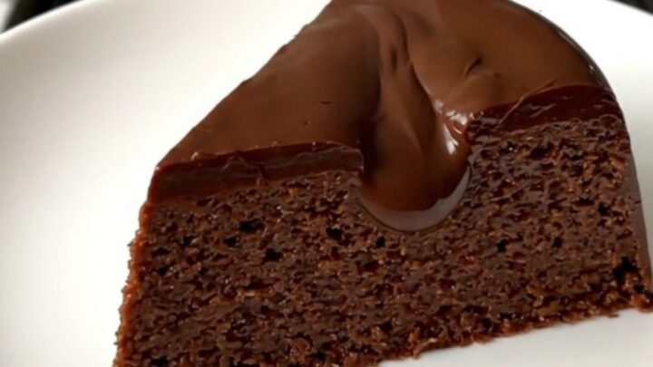 A glossy, steaming slice of chocolate chestnut fondant served on a clean white plate.