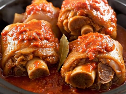 A rustic slow-cooked Provençal Pieds et Paquets dish served in a white bowl.