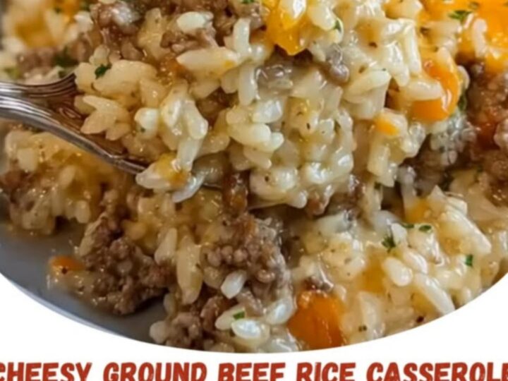 A steaming, cheesy ground beef and rice casserole in a blue dish with melted cheddar and parsley.