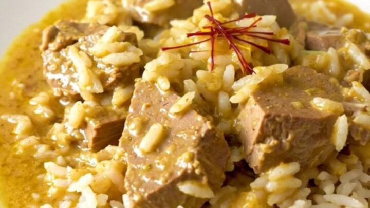 Slow cooker saffron veal blanquette served on a white plate with steamed rice.