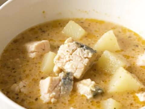 A rustic bowl of Charente fish and potato chowder with fresh herbs and a light, clear broth.