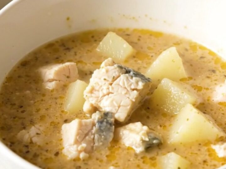 A rustic bowl of Charente fish and potato chowder with fresh herbs and a light, clear broth.