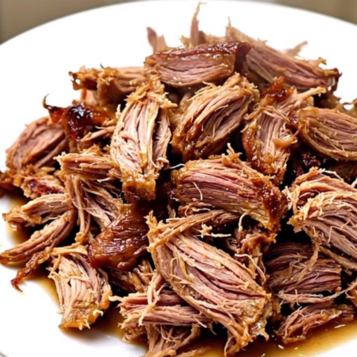 A slow cooker filled with raw pork roast, pineapple chunks, and sliced onions before cooking.