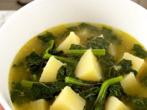A rustic Swiss chard and potato soup in a slow cooker on a quartz countertop.