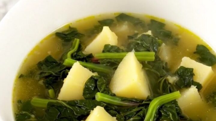 A rustic Swiss chard and potato soup in a slow cooker on a quartz countertop.