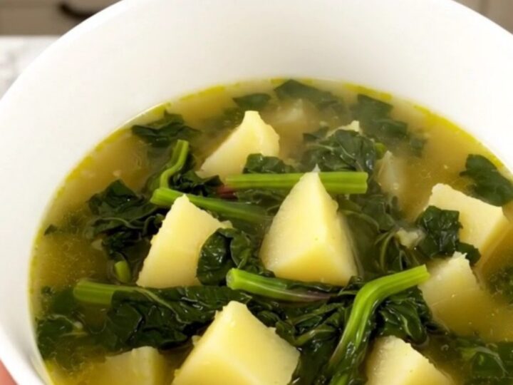 A rustic Swiss chard and potato soup in a slow cooker on a quartz countertop.